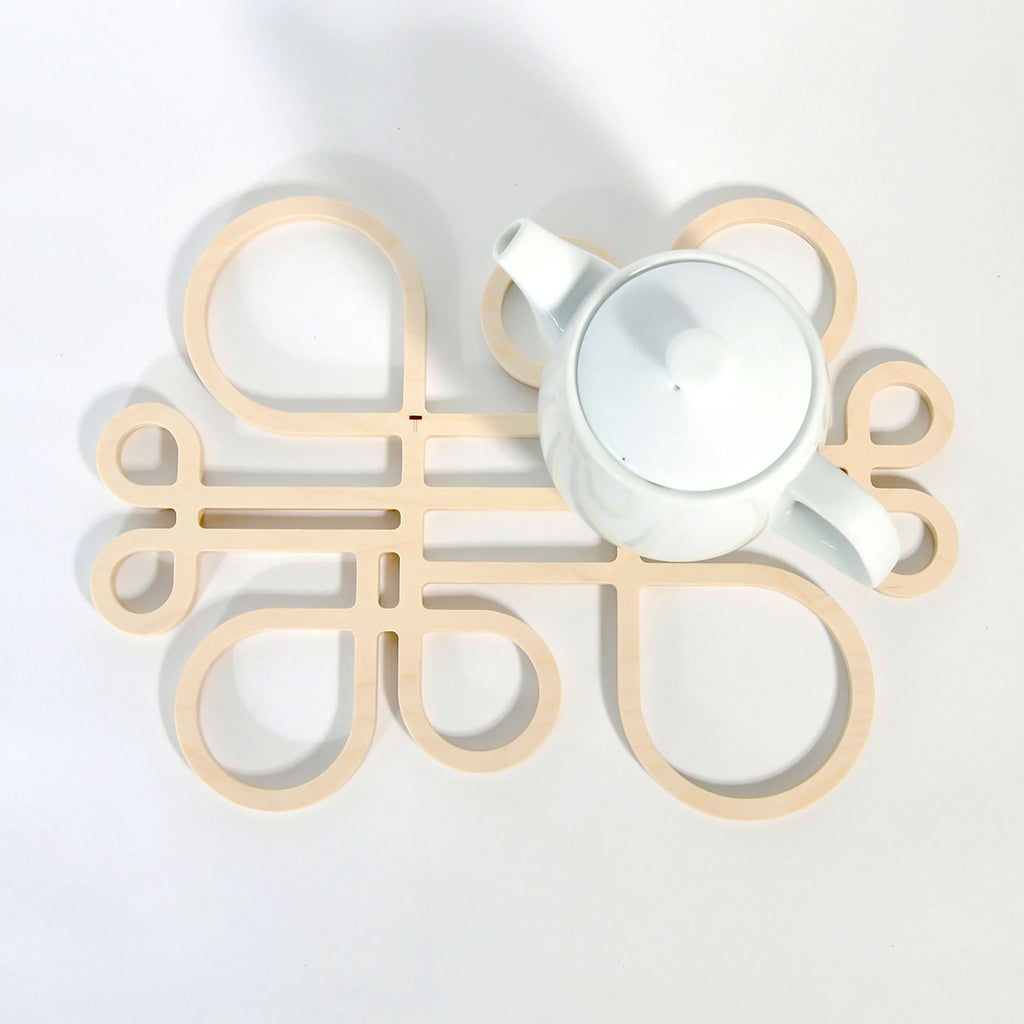 Decorate your table and protect the tablecloth with Inside Out wood trivets by Anne Thomas of TOMA Objects. Made of natural finish birch plywood. (A trivet is an object between a hot pan or serving dish and the table or countertop.) They have great heat resistance and prevent damage to surfaces caused by high heat. 