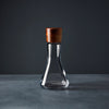 Nambe Vie Decanter – 10” designed by Chris Granneberg. The combination of the Vie Decanter’s square, glass body and rounded, wood stopper make this piece a style-standout. 