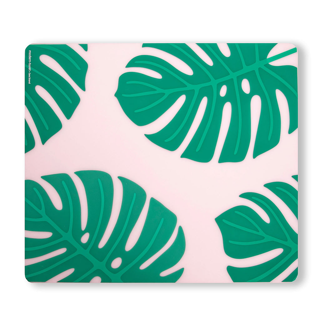 Monstera Deliciosa by Sara Strand for Modern-Twist. Made from plastic-free silicone & hand silk-screened with nature-inspired designs, the modern-twist monstera deliciosa placemat delivers eco-friendly, elegant style to your home. 
