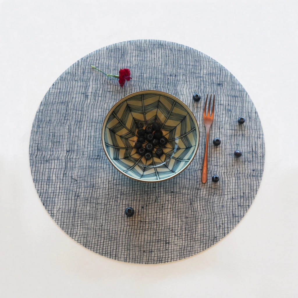 Round Placemat : Linen - Denim By Modern-Twist. UPC# 854796002027. Made from plastic-free silicone & hand silk-screened with nature-inspired designs, the modern-twist cocoon print placemat delivers eco-friendly, elegant style to your home. All modern-twist products are made with 100% pure, food-grade silicone that is European & FDA compliant.