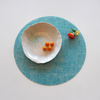 Round Placemat : Linen - Seafoam by Modern-Twist. UPC# 854796002041. This forgiving placemat protects your surfaces from heat & water damage with silky soft, memory-free silicone that never wears or tears. The non-porous & germ-free material repels the biggest spills & wipes clean with ease, leaving you free to enjoy the subtle designs & rich colors for many years to come.