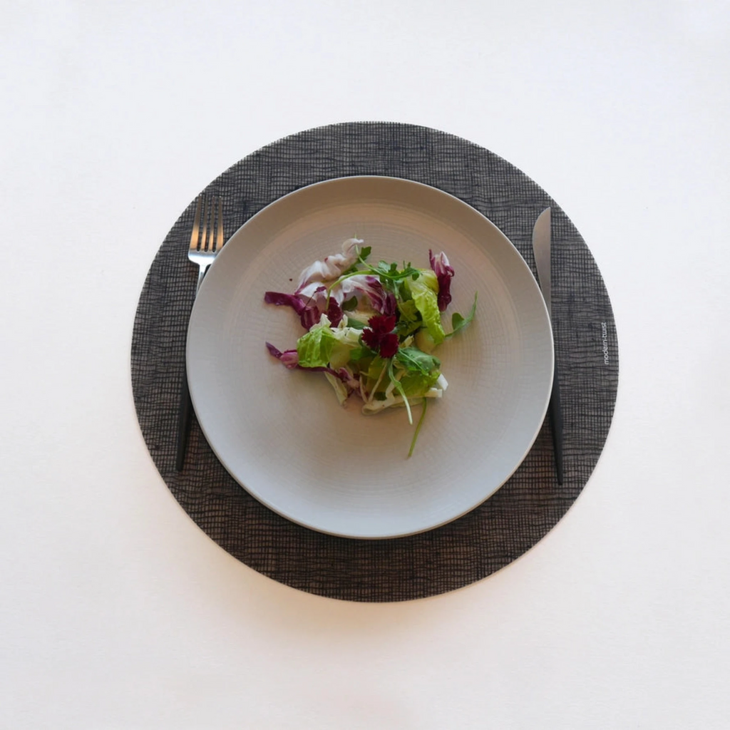 Placemat Round : Linen - Black by Modern-Twist. Bring beauty to your table with this soft, beautifully translucent pattern that enhances any surface while keeping lead, latex, phthalates, BPAs + other harsh chemicals far away from your dinner. 