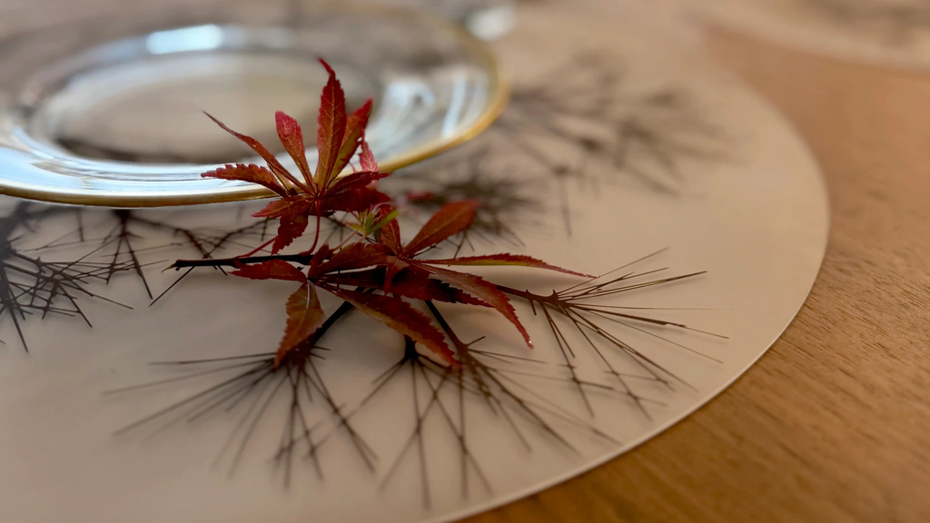 UPC# 854796002362. Round Placemat : Asawa Nest by modern-twist. Made from plastic-free silicone & hand silk-screened with nature-inspired designs, the modern-twist cocoon print placemat delivers eco-friendly, elegant style to your home. 