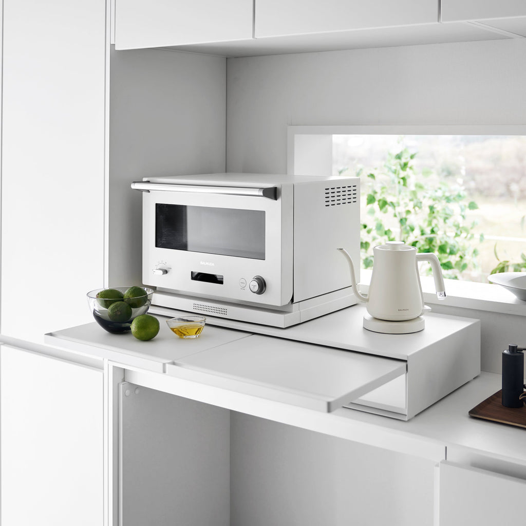 Reclaim the precious countertop space your kitchen appliances are hogging with this double two-way drawer. Place larger kitchen items on top and enjoy two extras drawers for utensils, dish towels, pot holders, tea trinkets—you name it!

Both sides feature vanishing pull-out shelves, providing ample space to perch a mug while you perfect your morning beverage, or rest that bowl of microwaved leftovers so you can season it up before carrying it to the table.