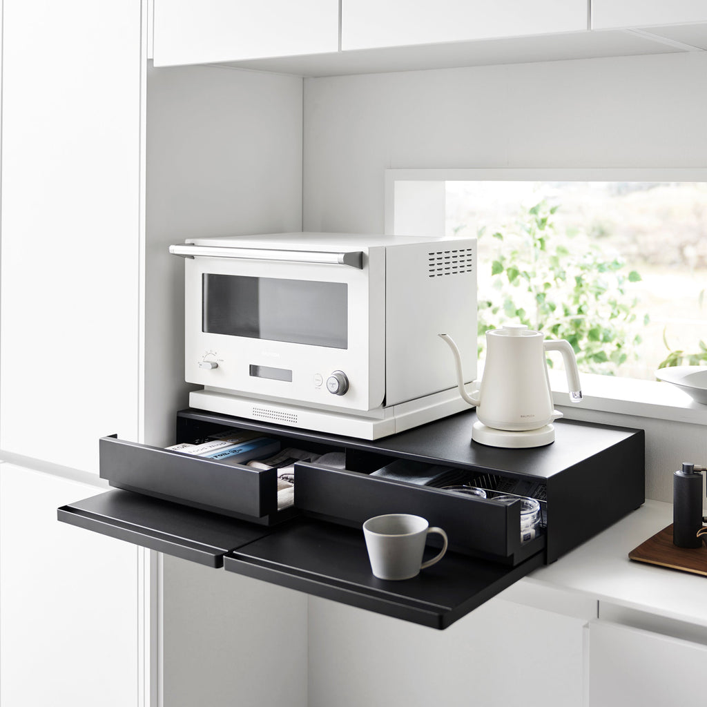 Reclaim the precious countertop space your kitchen appliances are hogging with this double two-way drawer. Place larger kitchen items on top and enjoy two extras drawers for utensils, dish towels, pot holders, tea trinkets—you name it!

Both sides feature vanishing pull-out shelves, providing ample space to perch a mug while you perfect your morning beverage, or rest that bowl of microwaved leftovers so you can season it up before carrying it to the table.