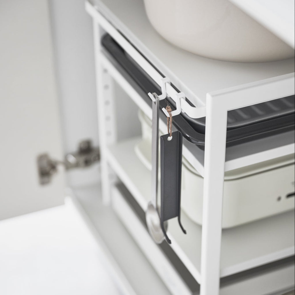 This three-tier steel kitchen storage rack is your helpful aid for cabinet organization! Adjust the bottom two shelves as you wish to store baking sheets, electric burners, pots and pans, and other bulky kitchen appliances that are otherwise hard to store. Make the most of vertical storage space with its adjustable shelves and hooks.