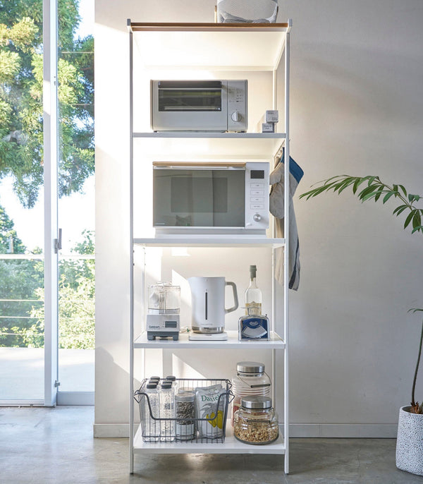 This kitchen appliance storage rack creates a dedicated space in the kitchen for your mid-sized appliances such as toaster ovens, microwaves, and blenders. The bottom compartment accommodates small refrigerators and garbage cans.