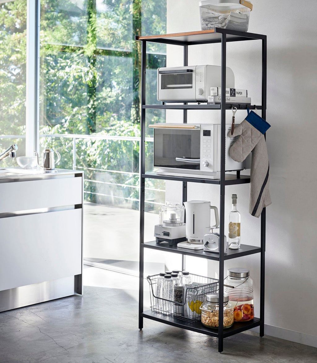 This kitchen appliance storage rack creates a dedicated space in the kitchen for your mid-sized appliances such as toaster ovens, microwaves, and blenders. The bottom compartment accommodates small refrigerators and garbage cans.