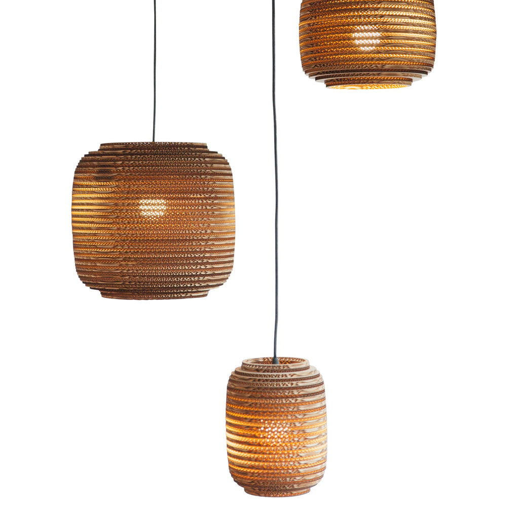 Scraplights are constructed from natural recycled cardboard precision cut by a laser. This gives the edges their classic dark appearance and enhances the warm light projected through the corrugation. Ausi is available in three colors and 3 sizes.