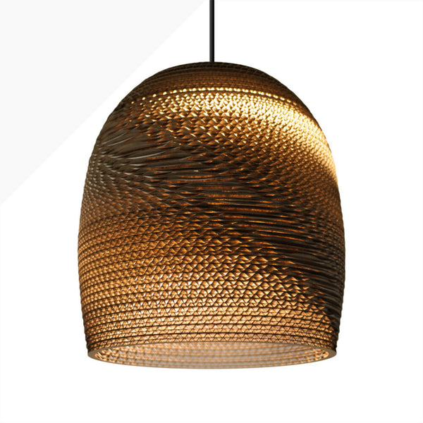 Handcrafted from 100% post-consumer recycled cardboard, our flagship Scraplights provide warm, intimate, and functional lighting for any occasion or space. Tough and elegant, each pendant is precision cut with a laser, giving the edges a slightly dark appearance and enhancing the warm light projected through the corrugation. Scraplights are assembled by hand using non-toxic adhesive and treated with a non-toxic fire retardant.