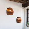 Handcrafted from 100% post-consumer recycled cardboard, our flagship Scraplights provide warm, intimate, and functional lighting for any occasion or space. Tough and elegant, each pendant is precision cut with a laser, giving the edges a slightly dark appearance and enhancing the warm light projected through the corrugation. Scraplights are assembled by hand using non-toxic adhesive and treated with a non-toxic fire retardant.