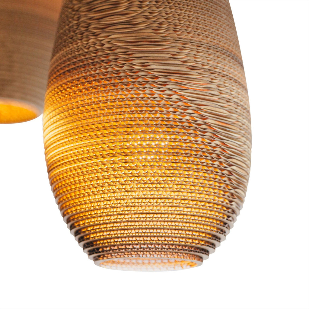 Scraplights are constructed from natural recycled cardboard precision cut by a laser. This gives the edges their classic dark appearance and enhances the warm light projected through the corrugation. The classic series includes many of the best-selling models such as the Moon and Disc, along with newer designs like the Hive and Nest.