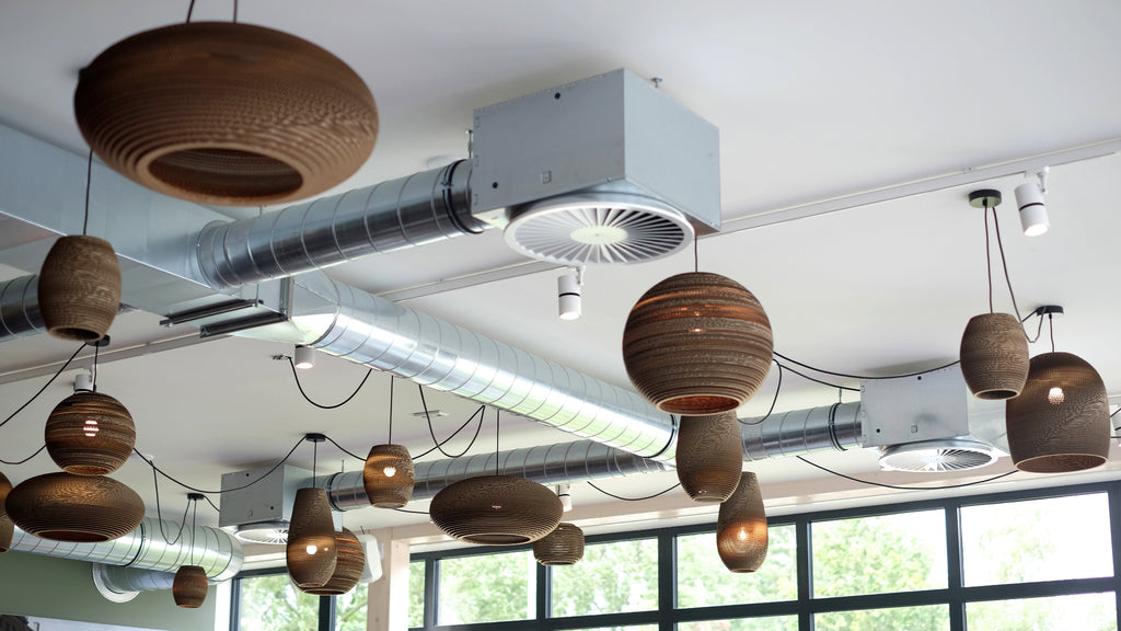 Handcrafted from recycled or pure white cardboard, Graypants’ flagship Scraplights series provides warm, intimate, and functional lighting for any occasion or type of space. Tough and elegant, each shade is precision cut with a laser (natural & blonde shades) or precision cut on advanced machinery (white shades) and assembled by hand using a nontoxic adhesive. All Scraplights are treated with an environmentally friendly fire retardant and are inscribed with the name of their artisan maker!