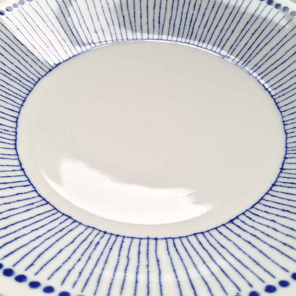 Clean lines and classic blue & white combination makes this charming series a keeper! These Japanese ceramic bowls feature a pattern of small blue dots along the rim with blue vertical strokes reminiscent of thin, straight tokusa plants. Made in Japan.