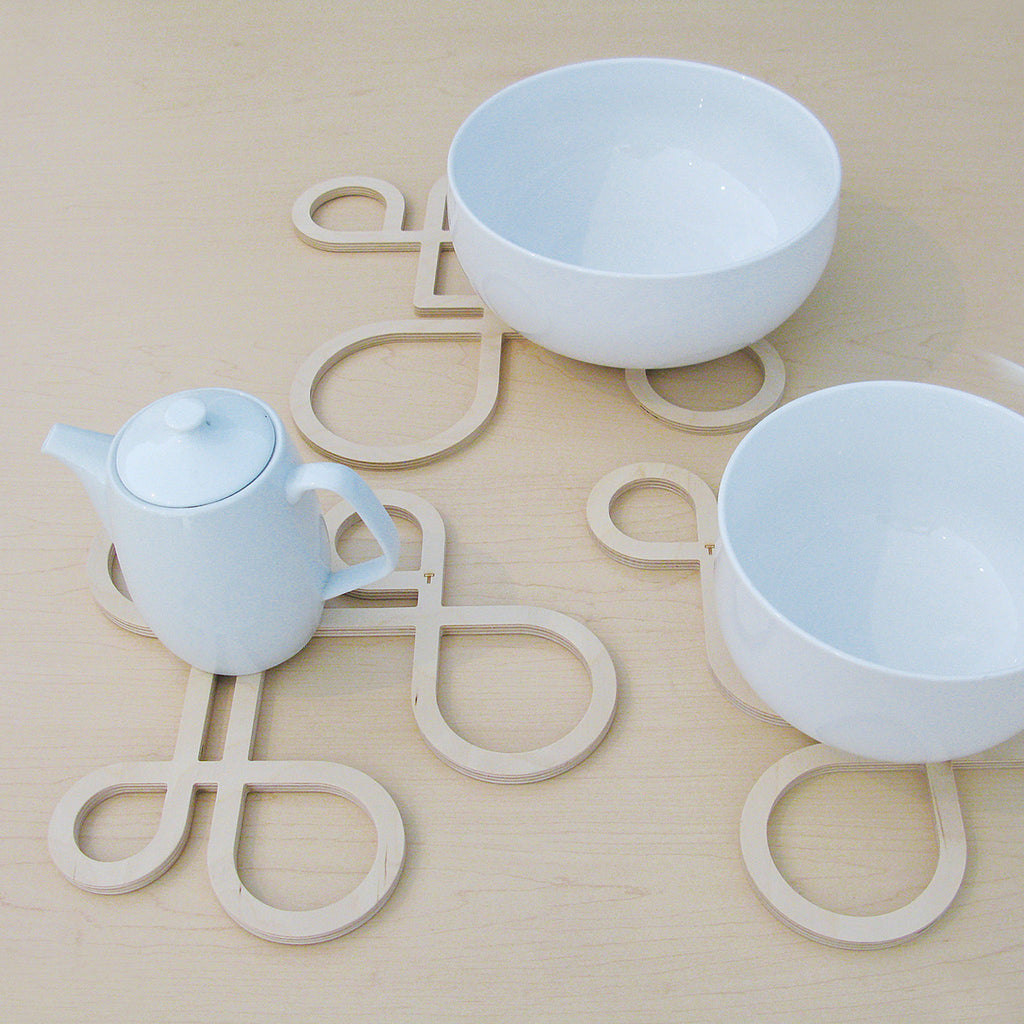 Decorate your table and protect the tablecloth with Inside Out wood trivets by Anne Thomas of TOMA Objects. Made of natural finish birch plywood. (A trivet is an object between a hot pan or serving dish and the table or countertop.) They have great heat resistance and prevent damage to surfaces caused by high heat. 