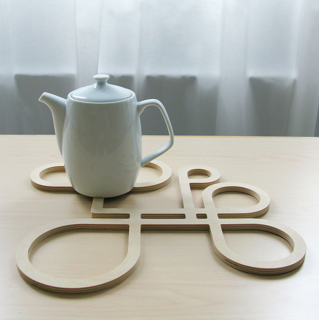 Decorate your table and protect the tablecloth with Inside Out wood trivets by Anne Thomas of TOMA Objects. Made of natural finish birch plywood. (A trivet is an object between a hot pan or serving dish and the table or countertop.) They have great heat resistance and prevent damage to surfaces caused by high heat. 