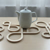 Decorate your table and protect the tablecloth with Inside Out wood trivets by Anne Thomas of TOMA Objects. Made of natural finish birch plywood. (A trivet is an object between a hot pan or serving dish and the table or countertop.) They have great heat resistance and prevent damage to surfaces caused by high heat. 