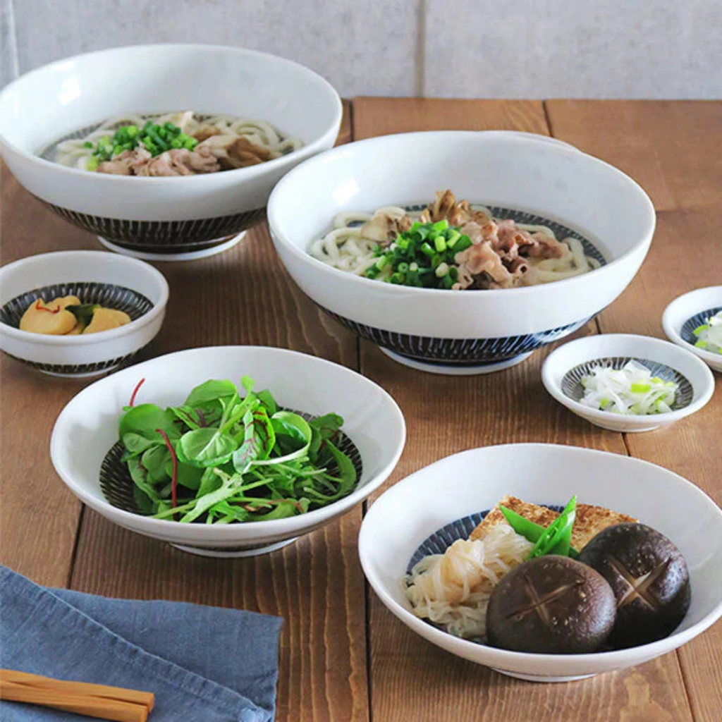 Tobikanna Indigo Blue Series. Satin Indigo Tobi Kanna design serving/noodle bowl. 8-3/8" diameter x 3-1/4"h. 40 oz. capacity.
Dishwasher/microwave safe. Ceramic.
Made in Japan. SKU 140-060.