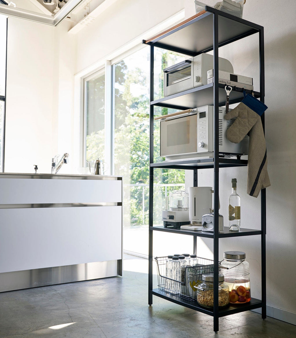 This kitchen appliance storage rack creates a dedicated space in the kitchen for your mid-sized appliances such as toaster ovens, microwaves, and blenders. The bottom compartment accommodates small refrigerators and garbage cans.