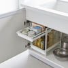 Two tier under-sink storage with sturdy steel frame. Pull out shelves keep everything within reach. The upper drawer has four adjustable height positions, spaced approximately 2" apart, to fit various storage needs. The top drawer can hold approximately 11 lbs.