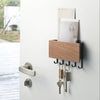 Yamazaki Home Rin Steel Wood Magnetic Key Rack comes with screws and anchors for wall mounting or with a magnet to adhere to a metal door (or the side of your fridge). 