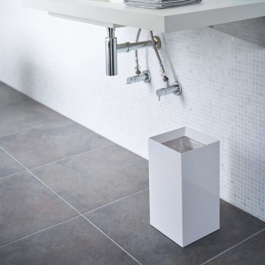 A clever interlocking design helps keep trash and liners out of sight. Built-in hooks hold a plastic liner bag in place. A standard, 13"x 20"grocery bag should fit Tower Short trash can; a 20"x22" bag would ideal for Tower Wide version. Designed in Japan. Made in China.