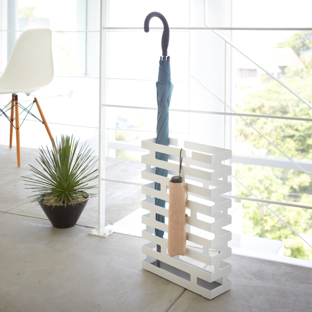 Yamazaki Home Brick Rectangle White Umbrella Stand. SKU 2360. Keep long umbrellas upright in the non-slip holder while looping hand umbrellas on top rungs.