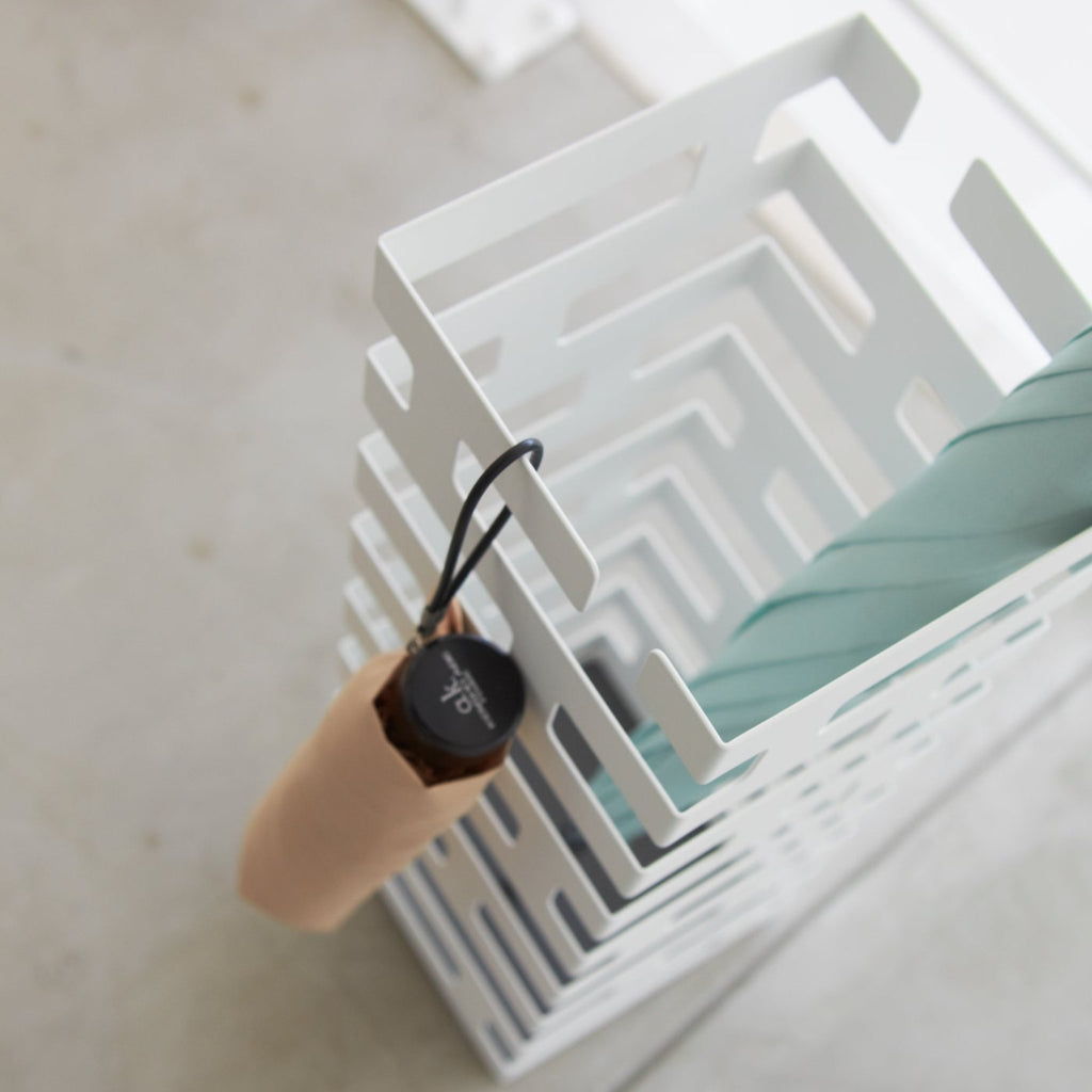 Yamazaki Home Brick Square White Umbrella Stand. SKU 2362. Keep long umbrellas upright in the non-slip holder while looping hand umbrellas on top rungs.