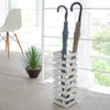 Yamazaki Home Brick Square White Umbrella Stand. SKU 2662. This brickwork-inspired umbrella stand offers both eye-catching design and functionality. Keep long umbrellas upright in the non-slip holder while looping hand umbrellas on top rungs.