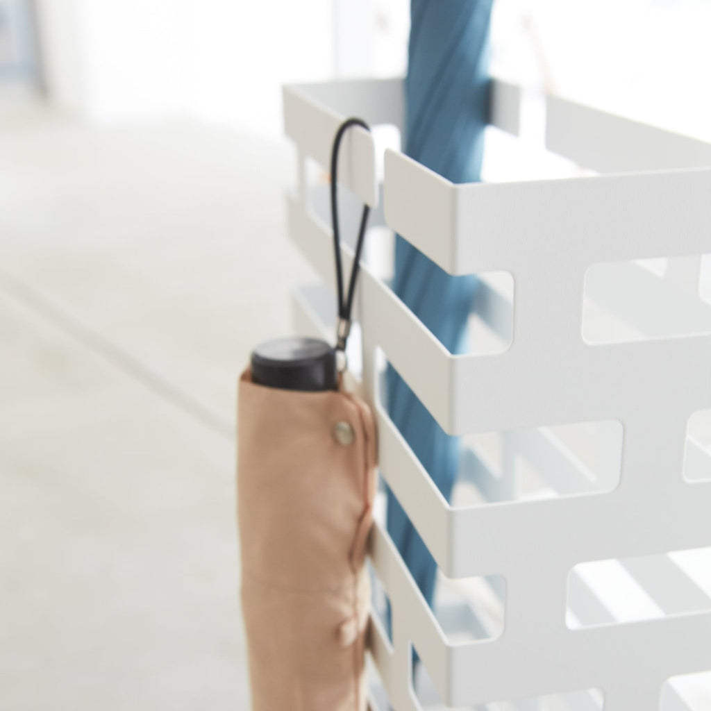 Yamazaki Home Brick Umbrella Stand. Looping hand umbrellas on top rungs.