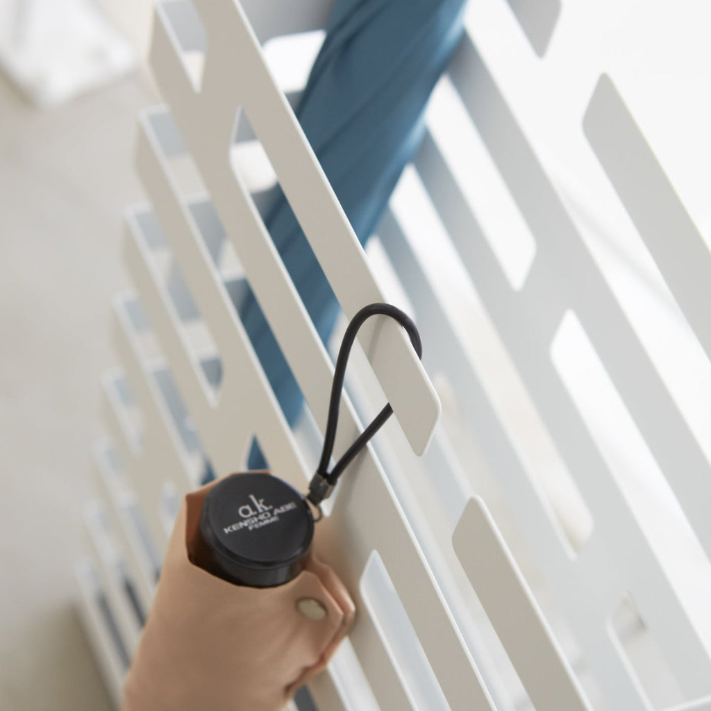 This brickwork-inspired umbrella stand offers both eye-catching design and functionality. Keep long umbrellas upright in the non-slip holder while looping hand umbrellas on top rungs.