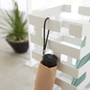 Keep long umbrellas upright in the non-slip holder while looping hand umbrellas on top rungs.