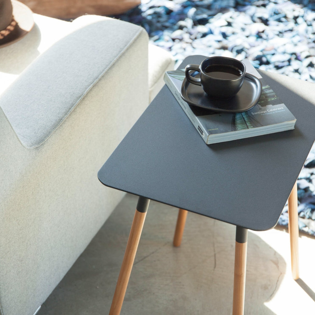 Wipe clean with a soft, damp cloth, and wipe dry. Avoid harsh materials. Use warm water and mild soap, if necessary. Dry immediately. Continued exposure to liquids can cause stains on Plain Side table surface. Recommend using coasters when placing drinks on the table.