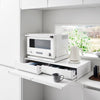 Both sides feature vanishing pull-out shelves, providing ample space to perch a mug while you perfect your morning beverage, or rest that bowl of microwaved leftovers so you can season it up before carrying it to the table.