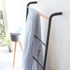 Whether you choose to store throw blankets, accessories, or bath towels on this versatile ladder, the sleek, modern design is sure to elevate items to decor status and add an artistic accent to your walls.