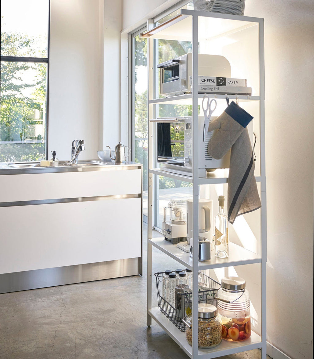 This kitchen appliance storage rack creates a dedicated space in the kitchen for your mid-sized appliances such as toaster ovens, microwaves, and blenders. The bottom compartment accommodates small refrigerators and garbage cans.