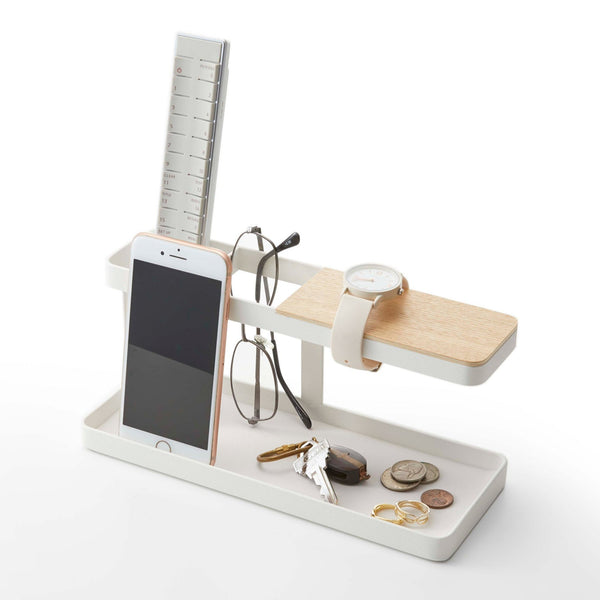 Yamazaki Home Tower Desk Organizer SKU 2299 White Steel. Two compartments keep items separated. A silicone mat rests at the bottom to keep items from sliding around. The extended arm (the section covered in wood) can be used for bracelets or up to two large watches. 