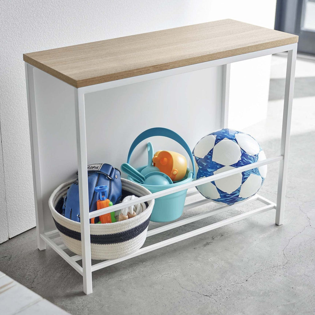 A front panel neatly conceals slippers, outdoor toys, or any other entryway clutter while keeping them within reach, making it the ideal storage solution for frequently-used items. 