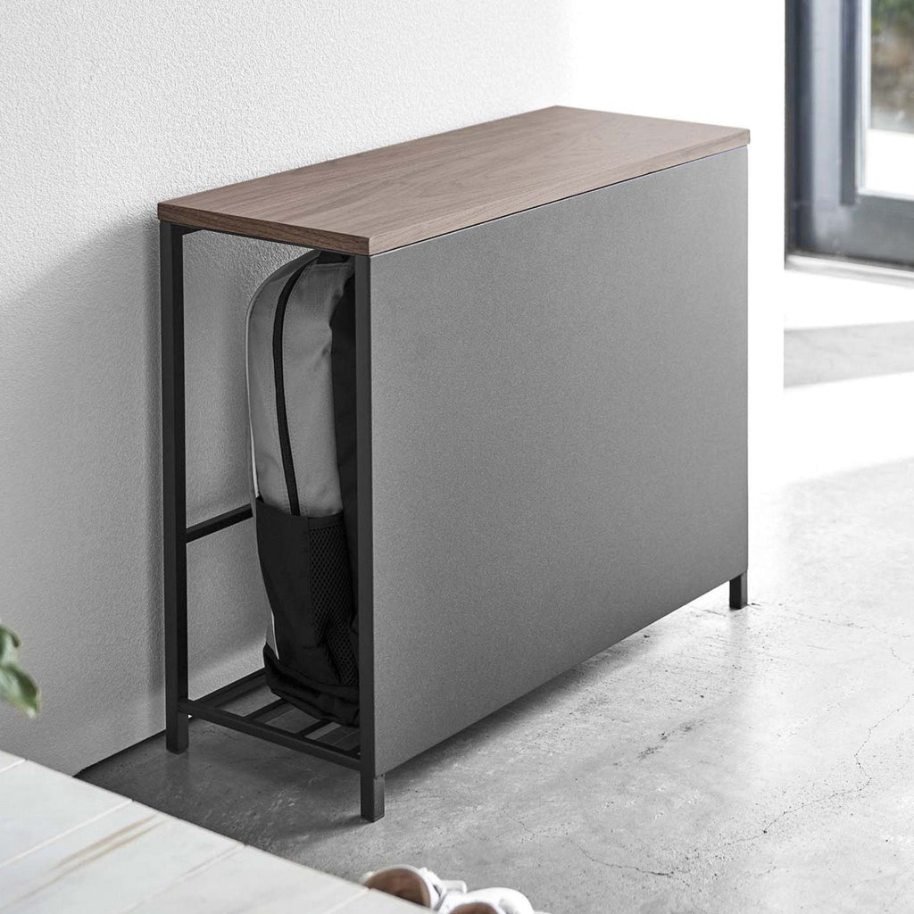 Part of the sleekness of this solution is a stylish front panel that hides the contents, while still allowing easy access from the side. 