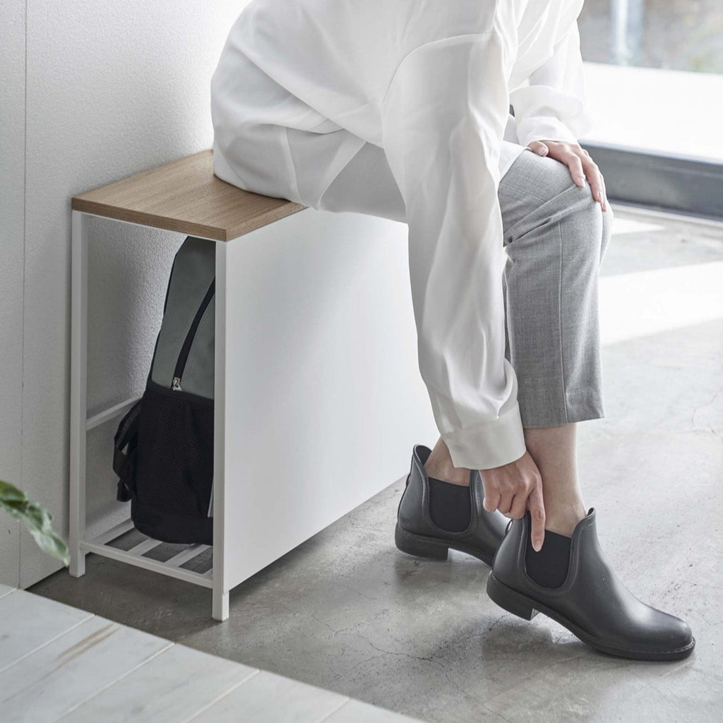 Better yet, it also doubles as a bench so you can easily tie your shoelaces or fasten buckles, as well as provide a convenient perch for your bags and purses when you walk in the door.