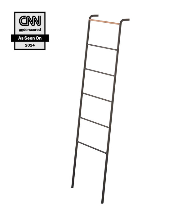Yamazaki Home Tower Leaning Storage Ladder Black SKU 2813. Prop Yamazaki Home Tower Leaning Storage Ladder against a living room wall as a canvas for throw blankets and linens, or in the bedroom for clothes, hats, scarves, and more. 