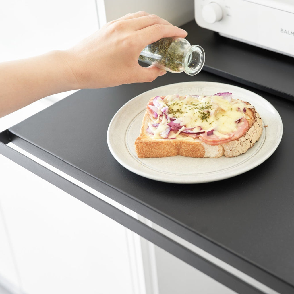 The vanishing pull-out shelf also provides ample space to perch a mug while you perfect your morning beverage or rest that bowl of leftovers you just microwaved so you can season it up before carrying it to the table. The shelf and drawer have stoppers to prevent them from sliding out. 