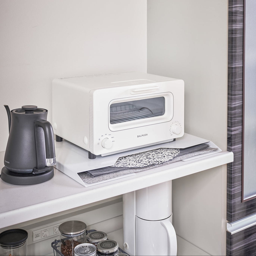 Yamazaki Home Tower Steel Magnetic Placemat Organizer mounts directly to a refrigerator or vertical surface with built-in magnets or use horizontally as a slim riser. 