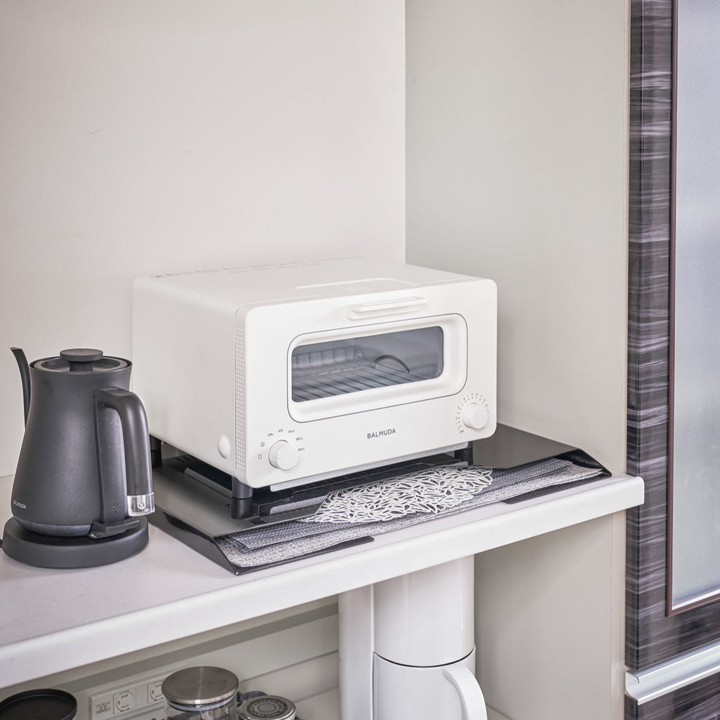 Yamazaki Home Tower Steel Magnetic Placemat Organizer mounts directly to a refrigerator or vertical surface with built-in magnets or use horizontally as a slim riser. 
