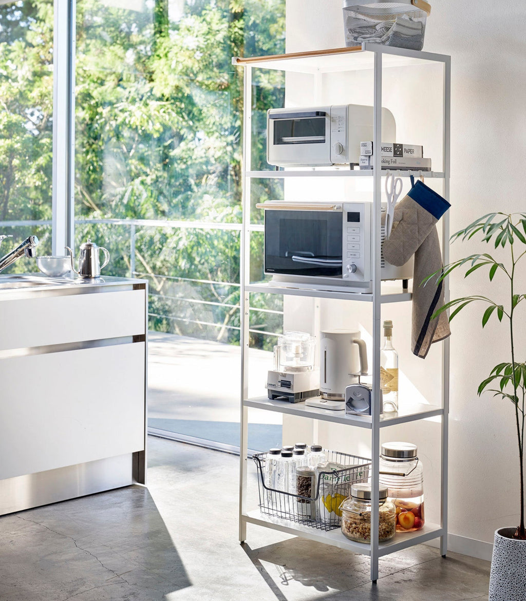 This kitchen appliance storage rack creates a dedicated space in the kitchen for your mid-sized appliances such as toaster ovens, microwaves, and blenders. The bottom compartment accommodates small refrigerators and garbage cans.