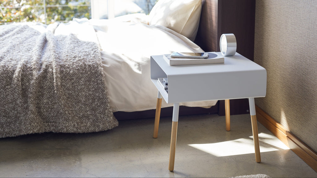 The tabletop is made from a powder-coated steel. It has a slightly textured surface. The wood legs are made from ash (white table) or walnut (black table) and are coated with a light finish. Easy to clean with a touch of a light soap and a damp cloth. Dry thoroughly.