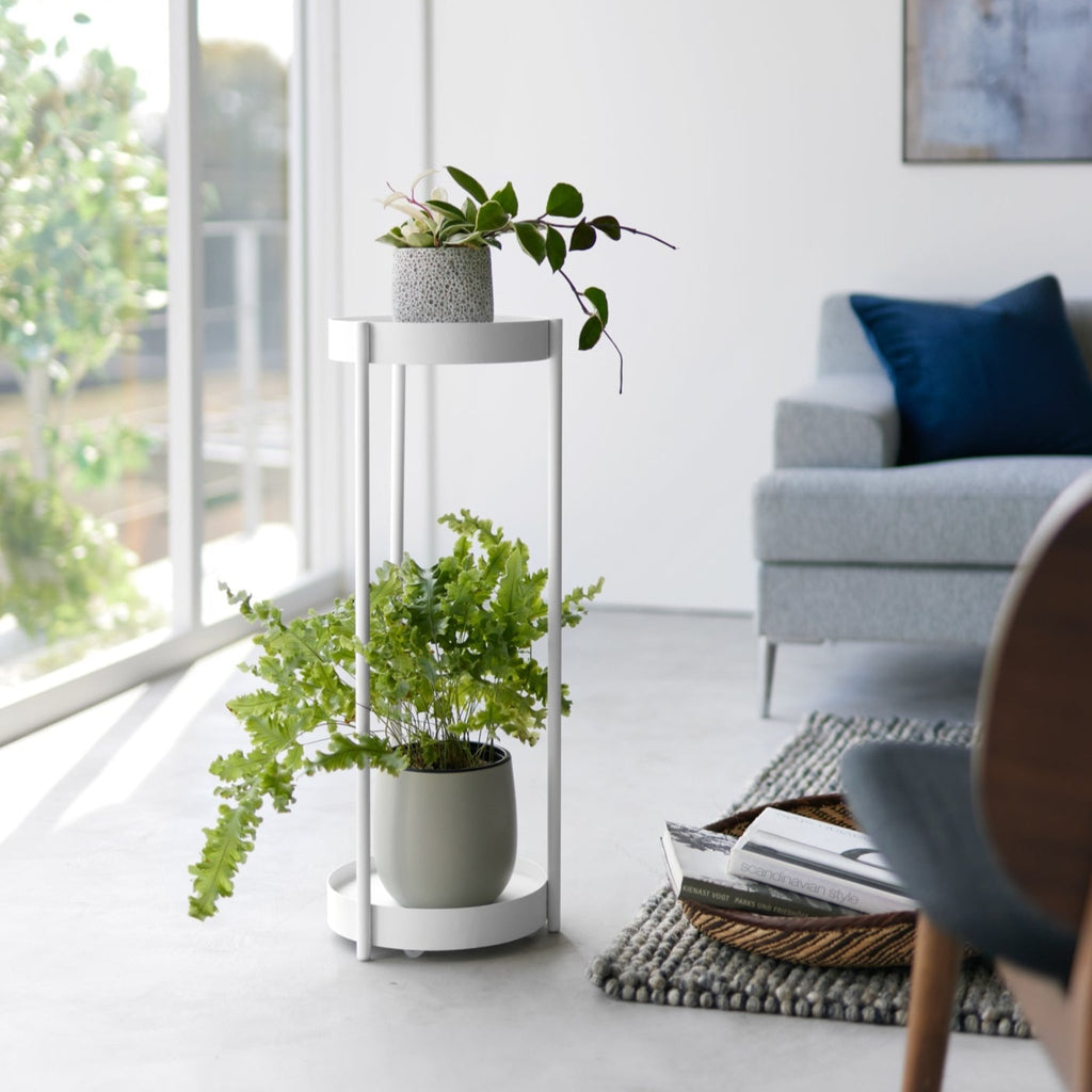 With a lightweight frame and caster wheels, this corner plant stand can easily be moved and placed anywhere in your home. Place it next to your couch and use the top tier as a side table, or wheel it up to your windows so your plants can catch more sun.