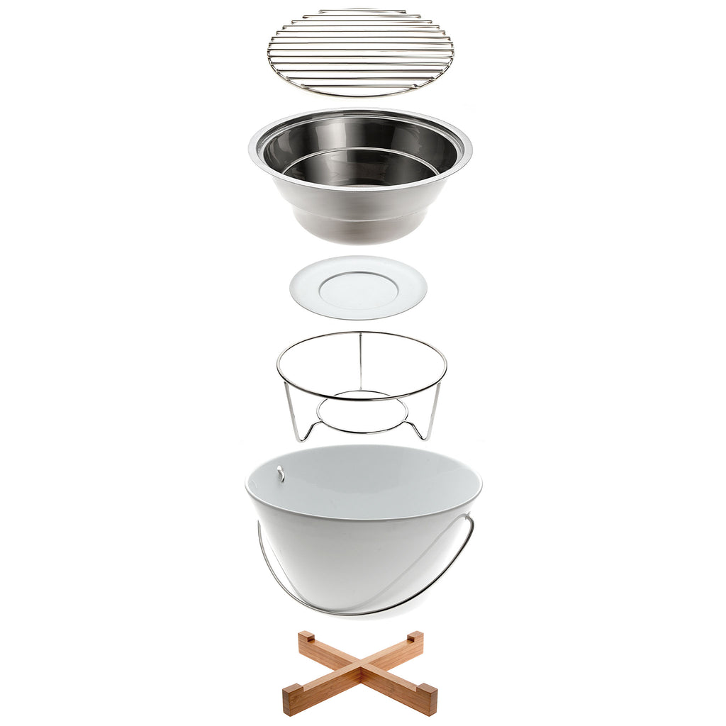 EVA SOLO Porcelain Table Grill. SKU: 571020. The outside of the table grill is made of porcelain. The grid and the insert that holds the glowing coals are made of stainless steel. Prior to lighting, the grill can be lifted by the steel handle. When hot, it stands securely on its trivet.