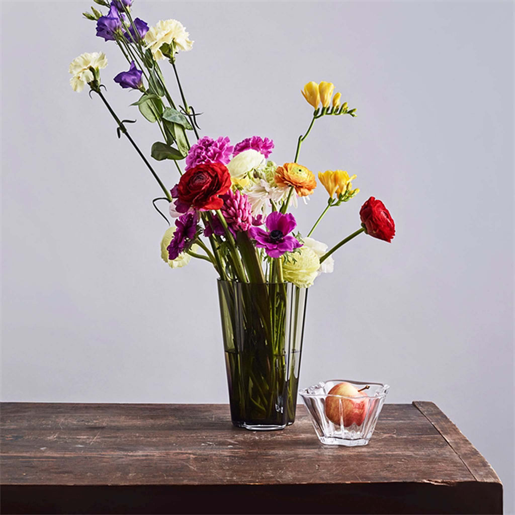 Iittala Alvar Aalto Collection Vase 220mm clear. The tall vase showcases long-stemmed flower bouquets perfectly while its clear colour makes this decorative vase a versatile part of any home décor. Ideal gift.