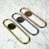 Souda Disco Bottle Opener. This may look like a huge paperclip, but its purpose is greater than keeping your TPS reports together. Featuring a minimal, geometric design, this metal piece will easily pop your favorite bottle. And it'll look great in your home bar thanks to a polished brass or silver finish.
